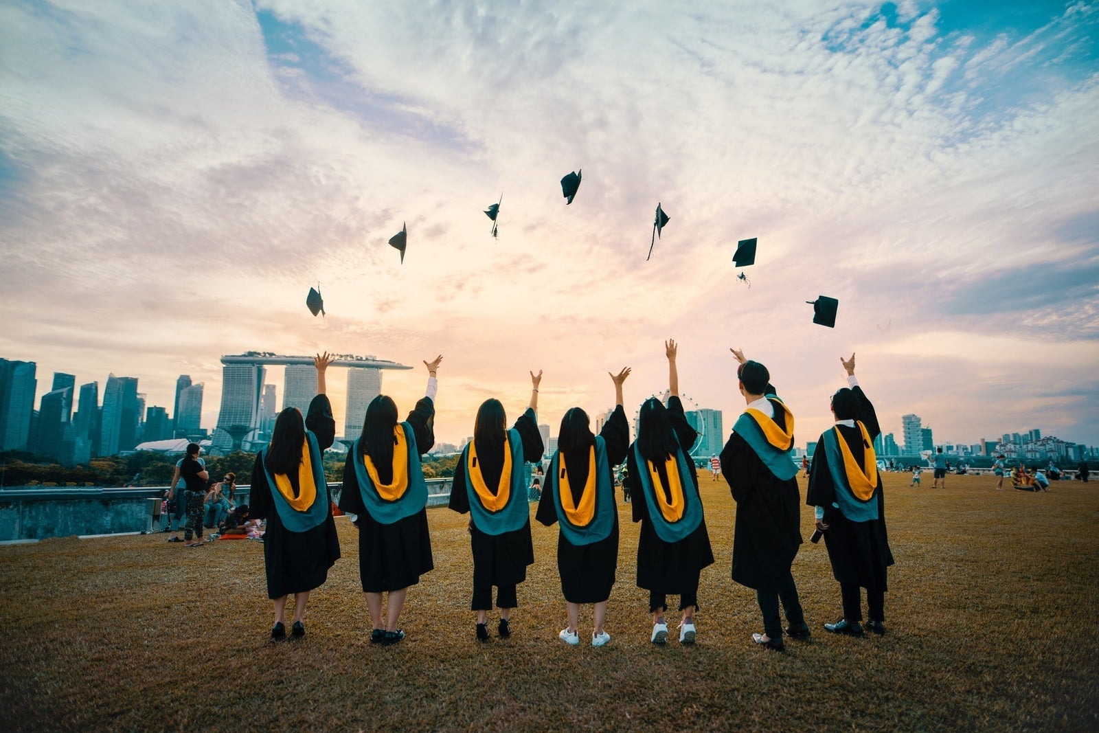 College graduates throwing caps
